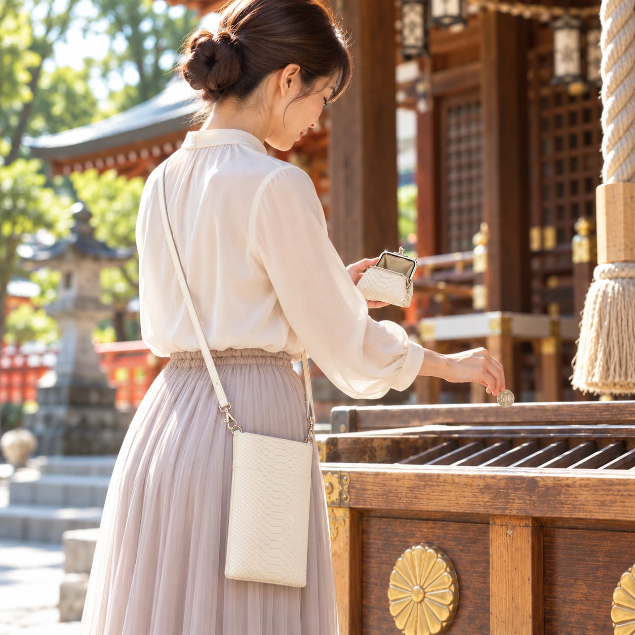 白蛇革のがま口からお賽銭を納める女性